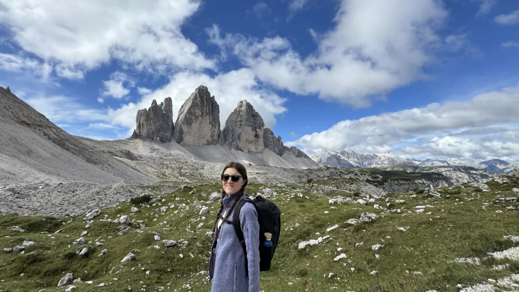 Catu smilling at the camera with the tre cime in the background