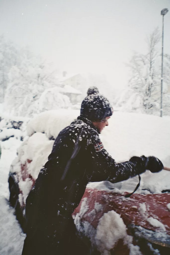 Car full of snow in front of the hotel Albergo Alpenrose